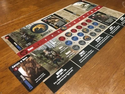 A player's faction board is slotted with various upgrade cards drafted each round.