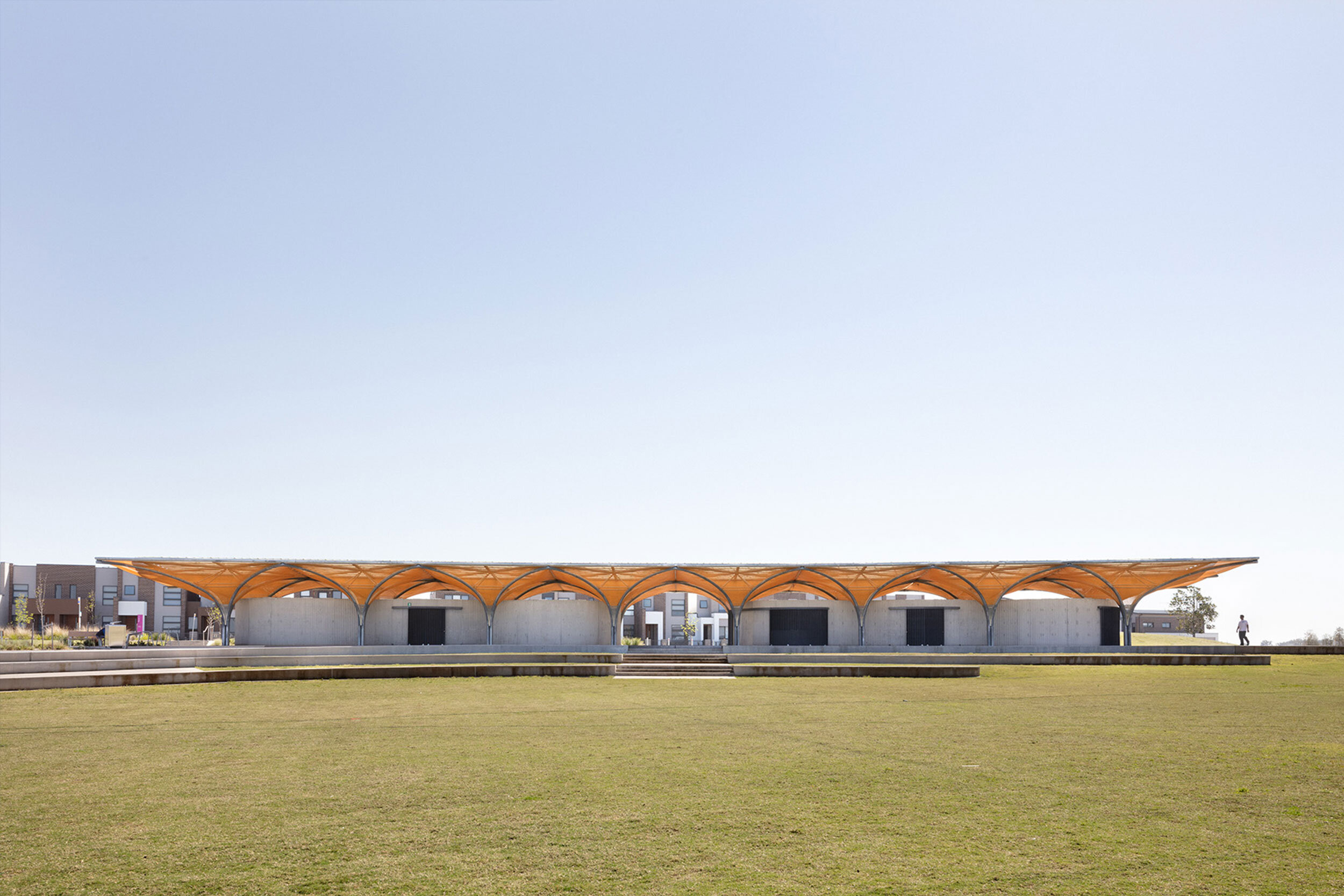 Dezeen: Golden polycarbonate mesh stretches across the canopy of this pavilion in Marsden Park, Sydney, designed by architecture practice CHROFI.