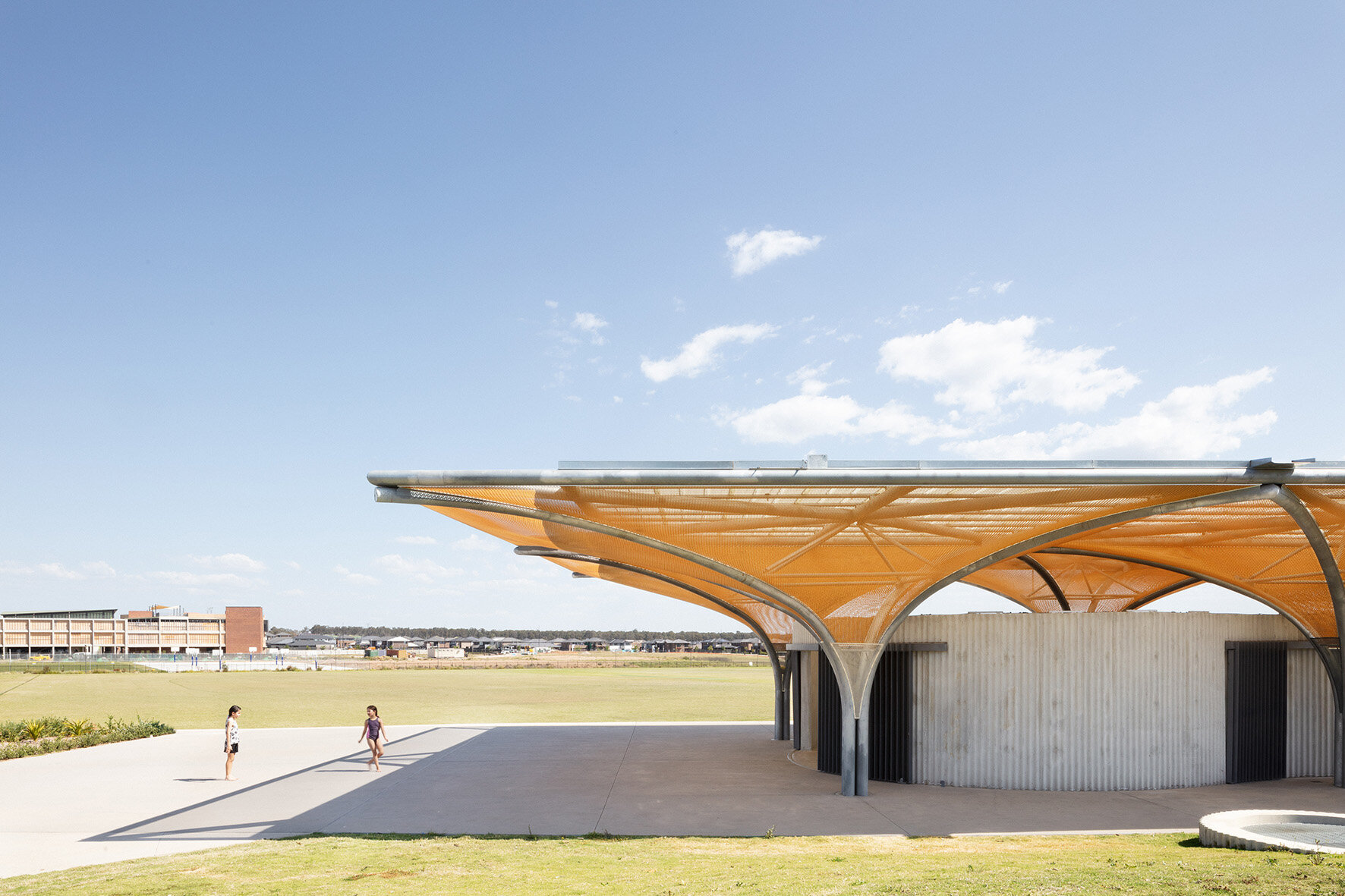 ArchitectureAU—Big-hearted Optimism: Marsden Park Amenities: In a new suburban community on Sydney’s fringe, a robust yet whimsical structure provides an injection of amenity, quality and participation via well-designed facilities, voids for socia