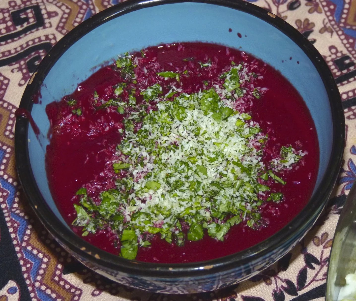 Indian spiced beet soup garnished with cilantro and coconut