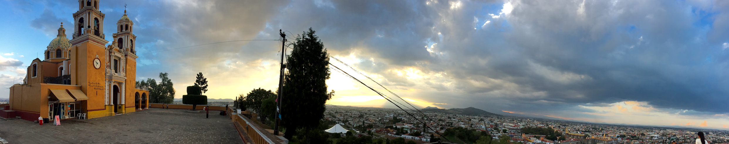Outside of the Church of La Virgen de los Remedios, on top of the Great Pyramid of Cholula, overlooking the city and a clouded Popocatépetl in the distance.