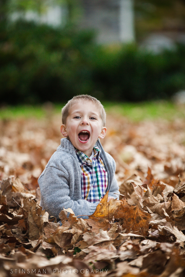 Smiling son in leaves