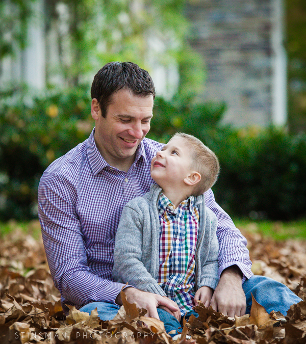 father and son sitting in leaves at princeton university