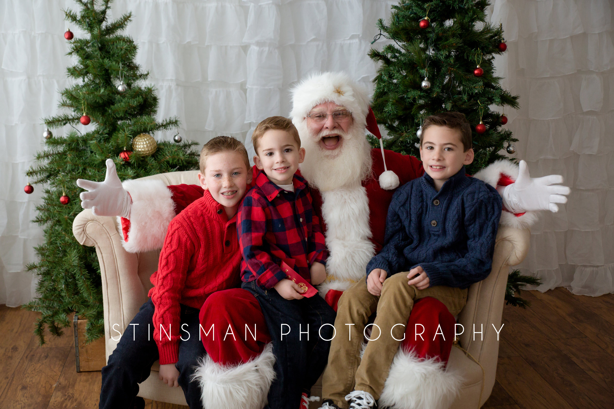 three brothers sitting on Santa's lap