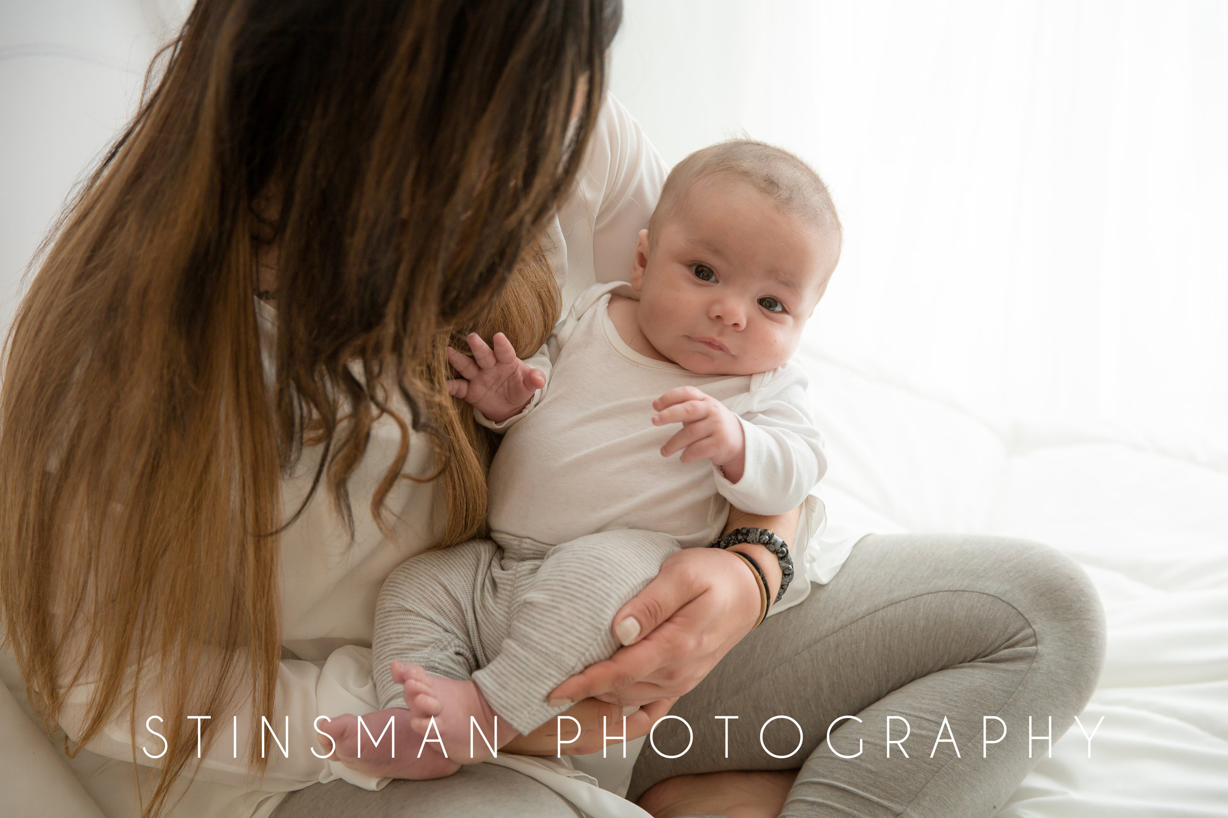 3 month old little boy looking up at the camera in studio in burlington nj with stinsman photography.