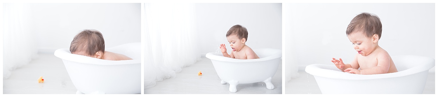 splashing in the tub for his first birthday photo shoot in burlington new jersey