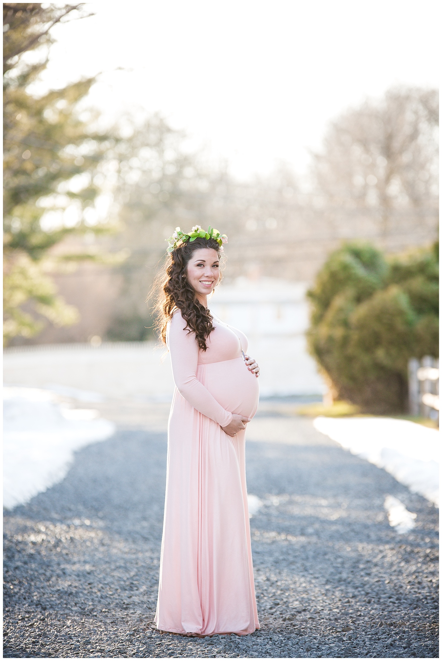 pregnant mom wearing pink for her maternity session wearing a flower crown