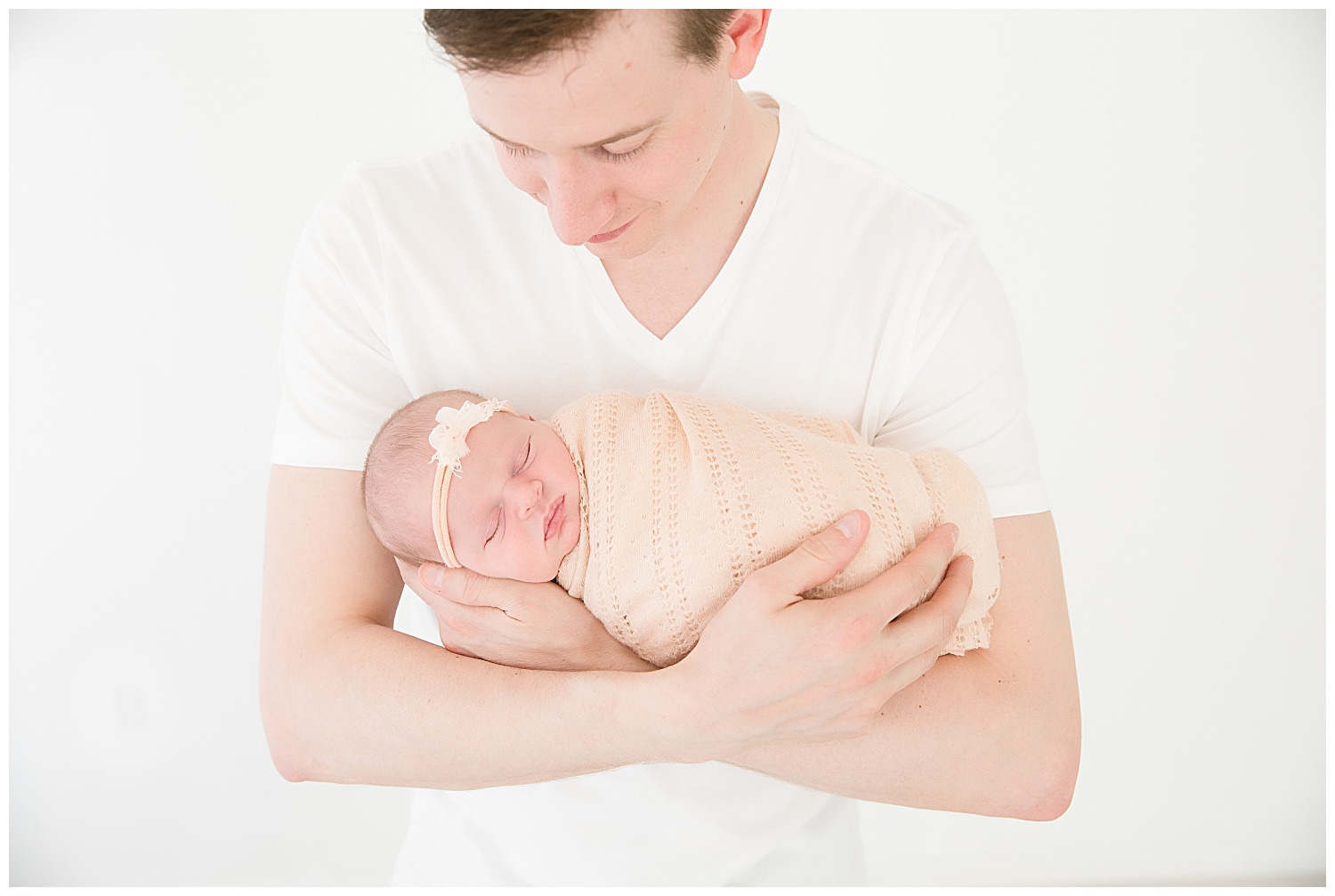 dad holding his newborn baby girl in burlington new jersey photo shoot