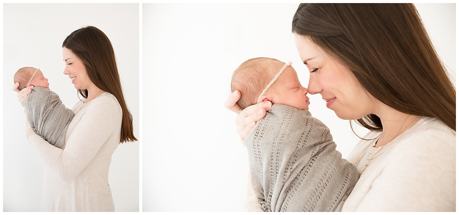 mom snuggling her newborn baby girl and giving eskimo kisses in newborn photo shoot in burlington new jersey studio