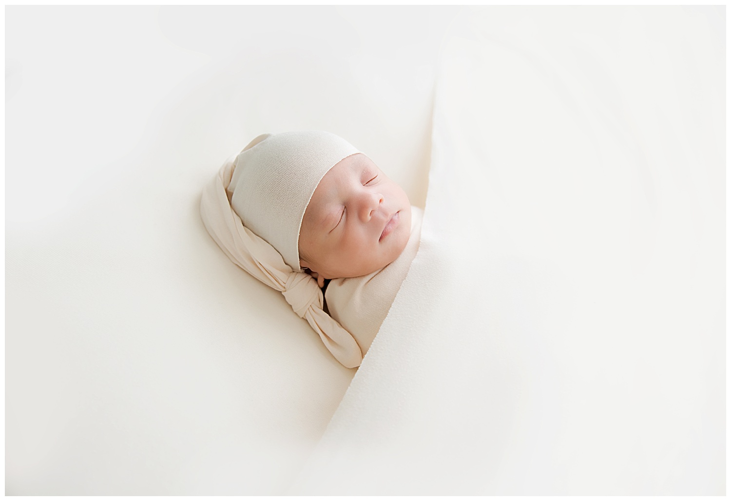 sleeping baby girl in a cream sleepy cap in burlington nj