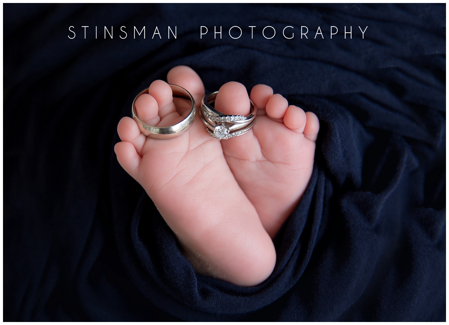 baby toes with wedding rings wrapped around in burlington nj studio