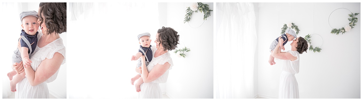 mom wearing a white dress with her son in a blue hat for mommy and me session in moorestown new jersey studio