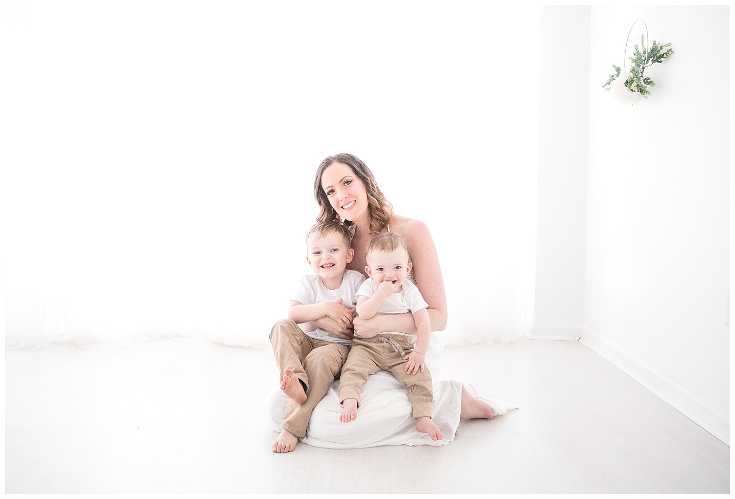 mom and kids looking at the camera and smiling in burlington new jersey studio