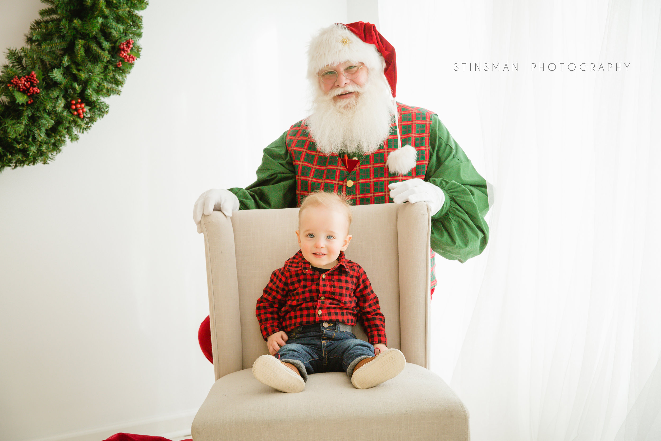 little boy sitting in a chair for his santa photo shoot in burlington nj picture studio