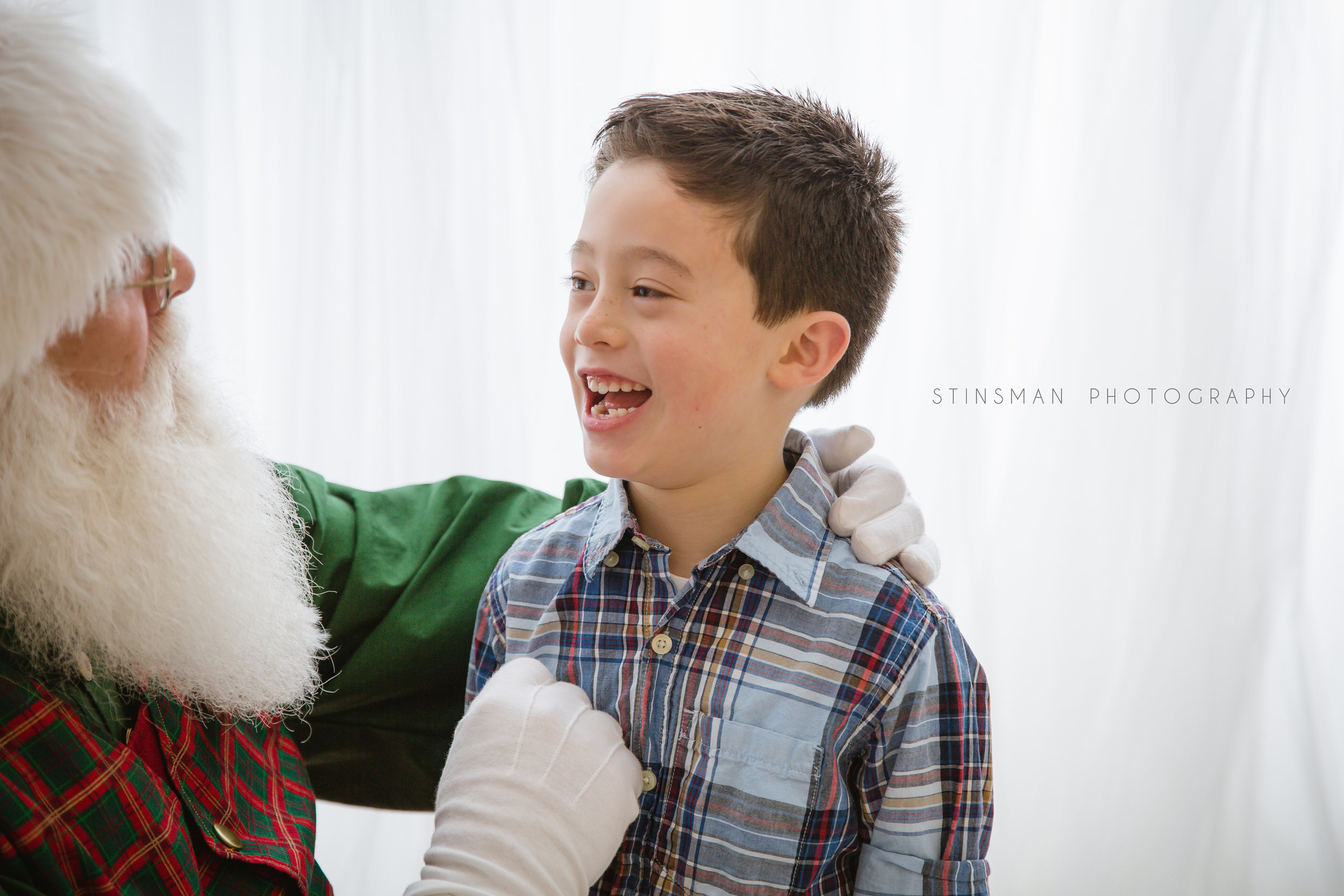 Santa checking out Tyler's lost tooth in burlington nj photo studio