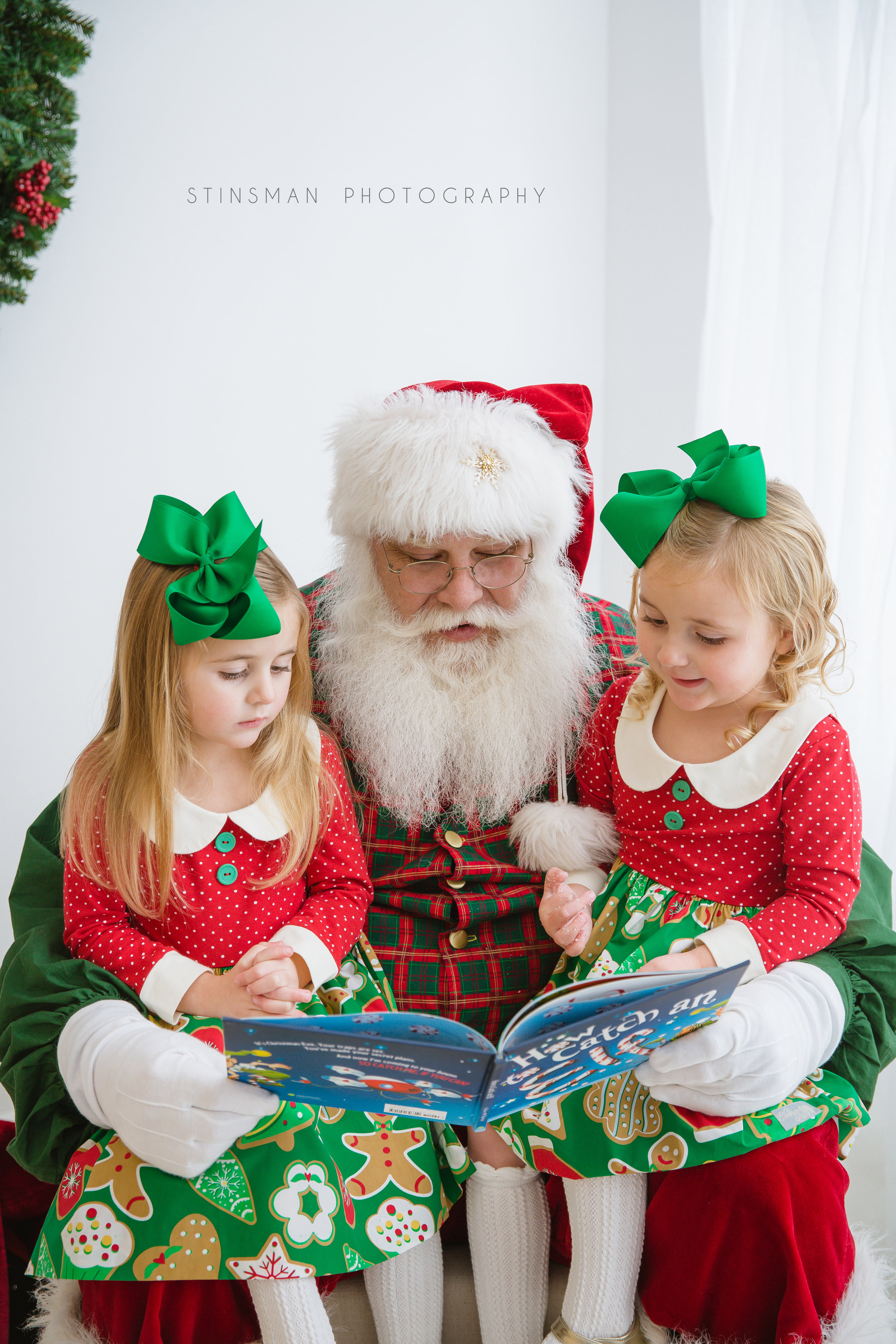 twin girls reading with Santa about how to catch an elf in burlington nj photo studio