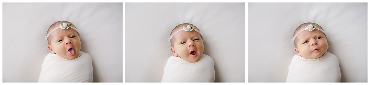 Baby girl wrapped in cream wearing a flower headband yawning and tired