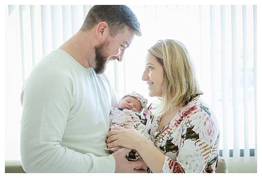 mom and dad with newborn baby girl