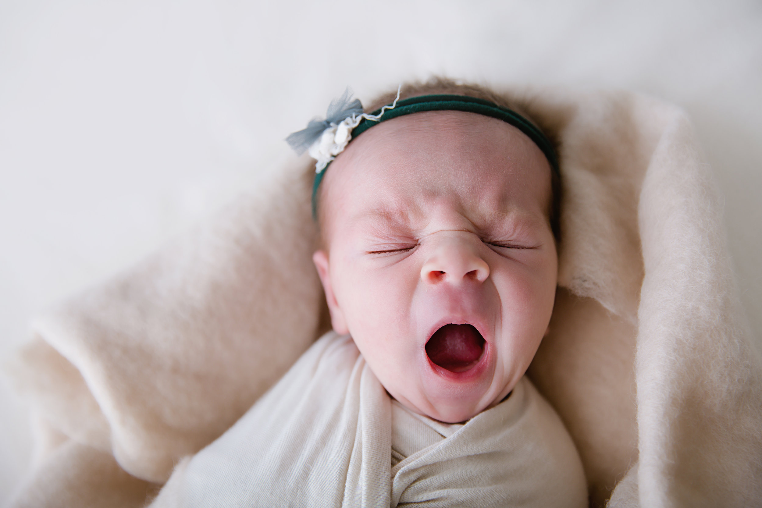 big yawning newborn baby girl