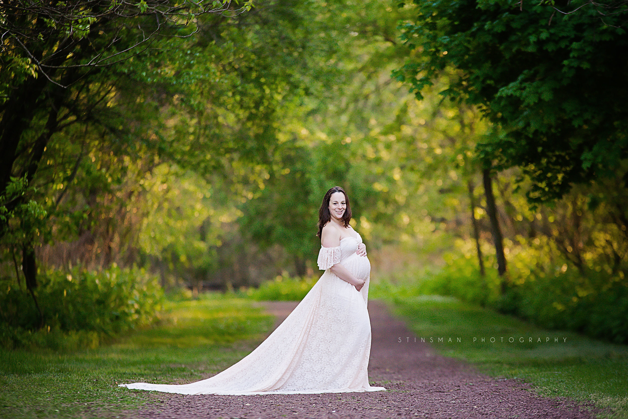 pregnant-mom-wearing-pink-lace-gown-with-a-train-at-palmyra-nature-cove-burlington-county-new-jersey.jpg
