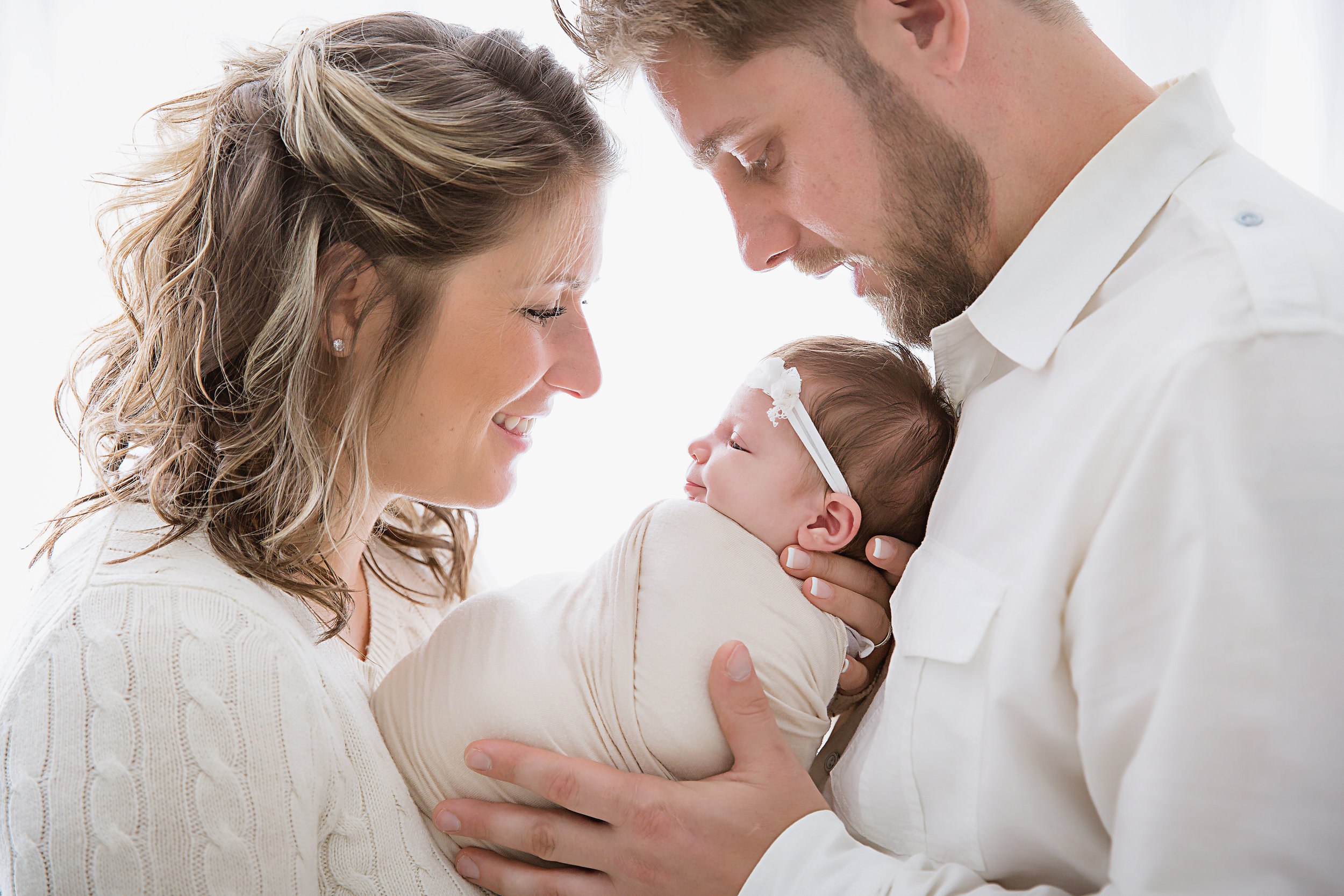newborn-parents-look-at-newborn-baby-girl