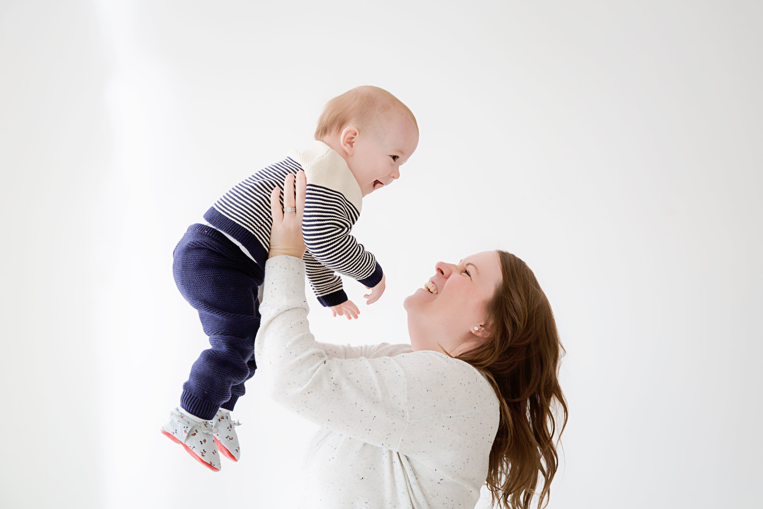 mom-holding-old-year-old-son-up-in-the-air