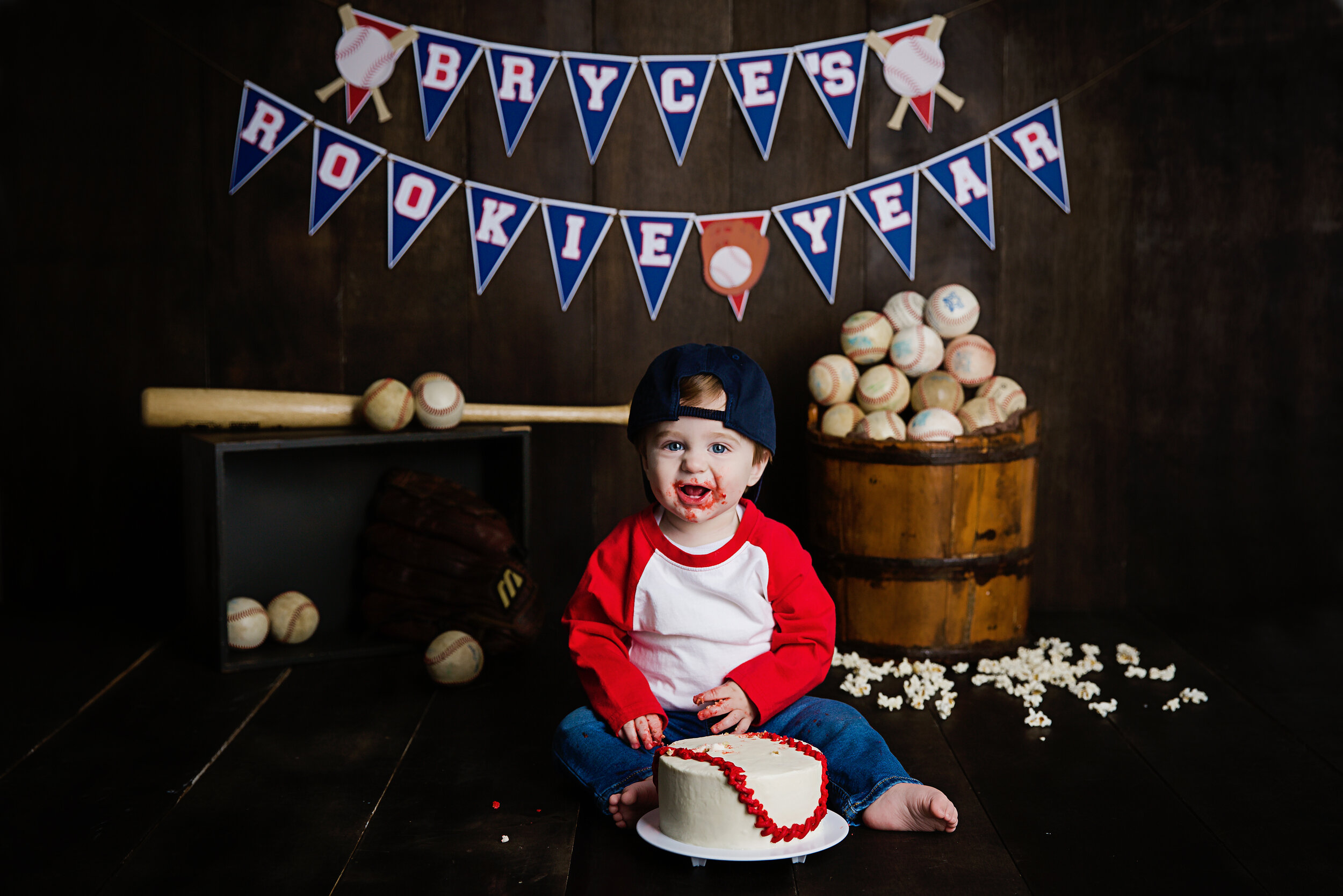 one-year-old-smiling-at-camera-during-his-cake-smash