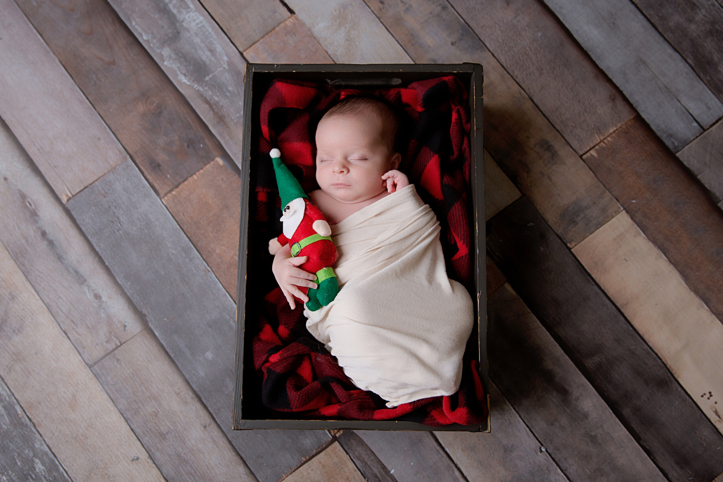 newborn-baby-swaddled-holding-santa