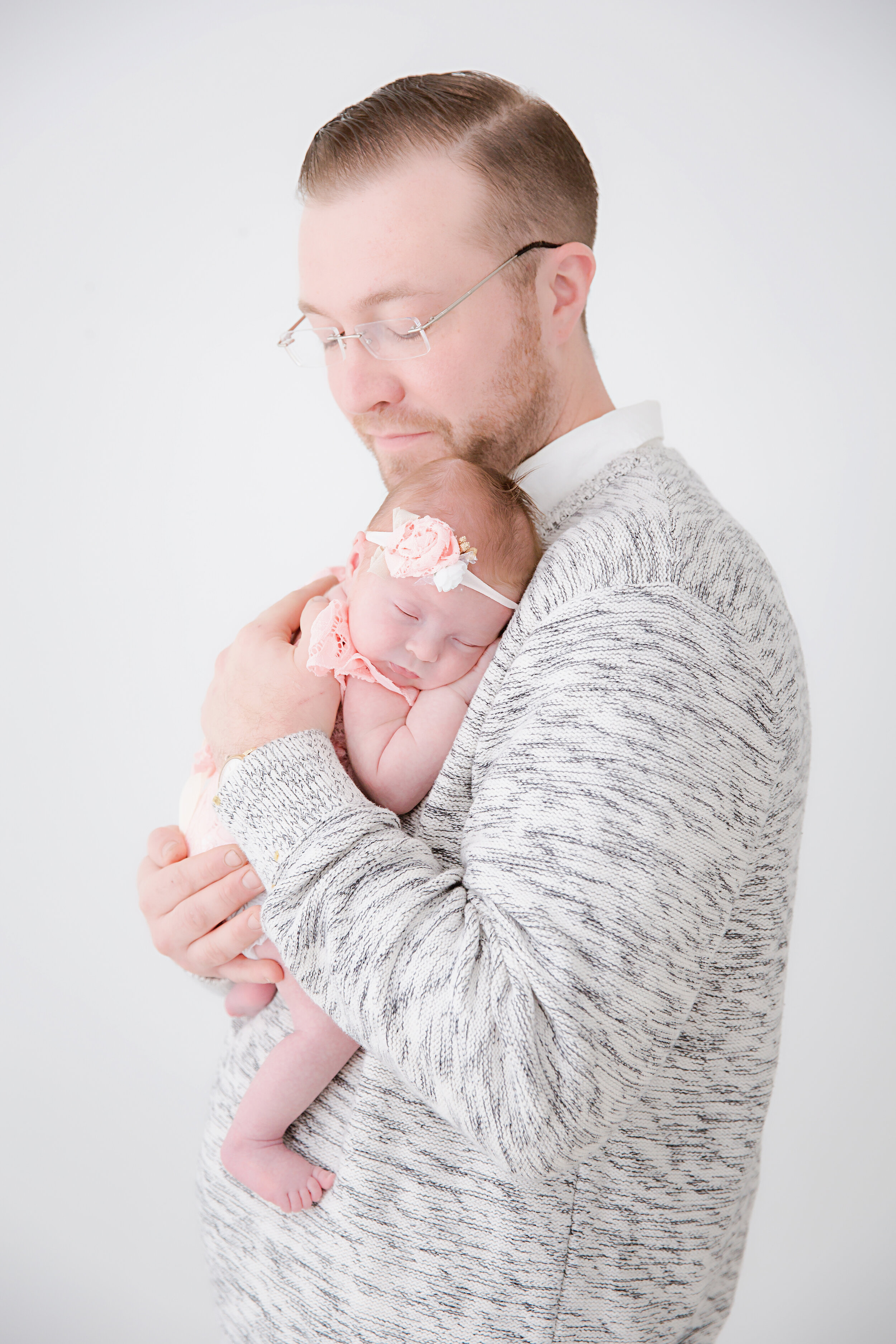 dad-holding-and-hugging-sleeping-newborn-baby-girl