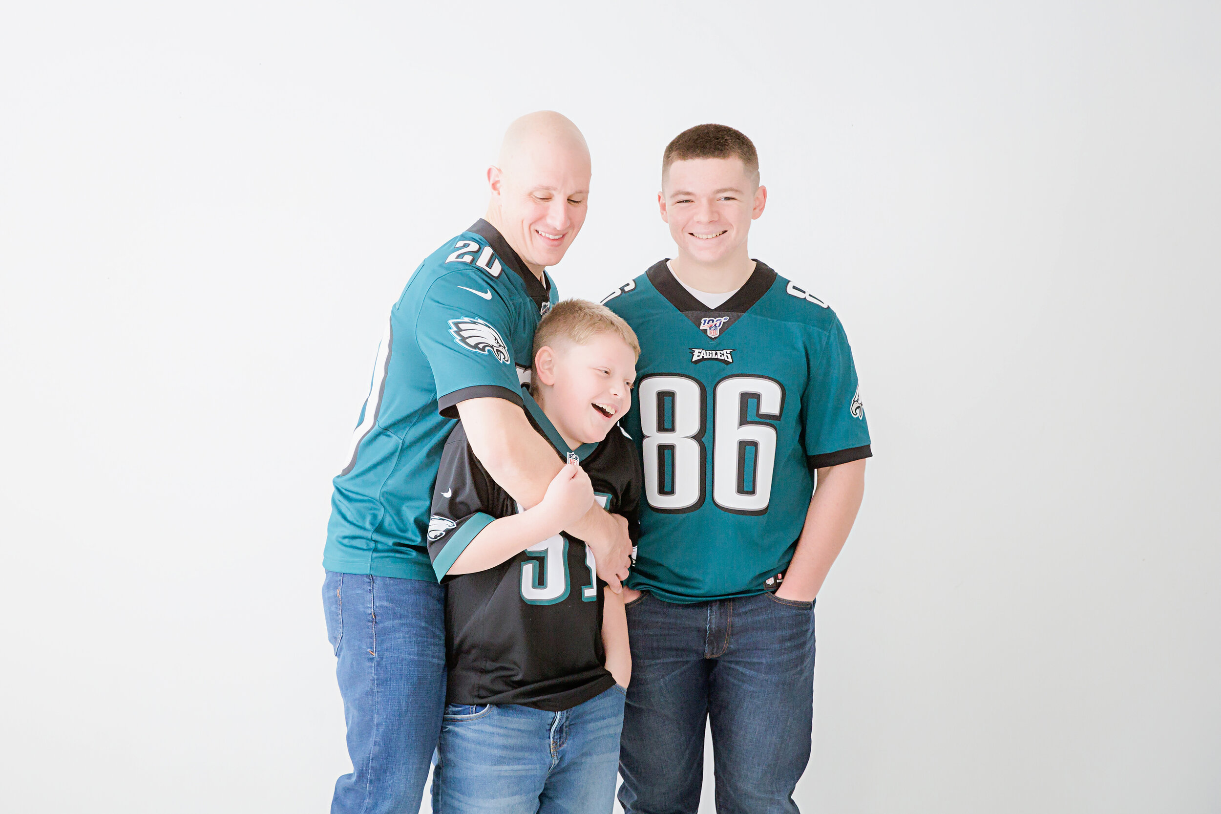 dad-and-sons-smiling-in-their-football-jerseys