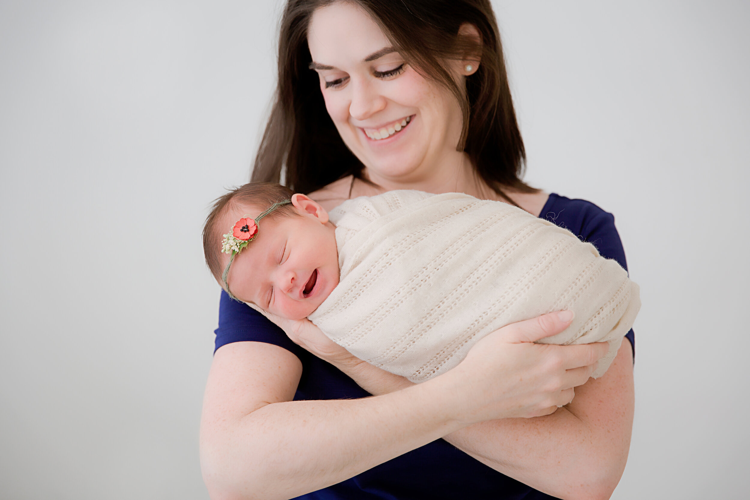 mom-holding-newborn-baby-girl-sleeping
