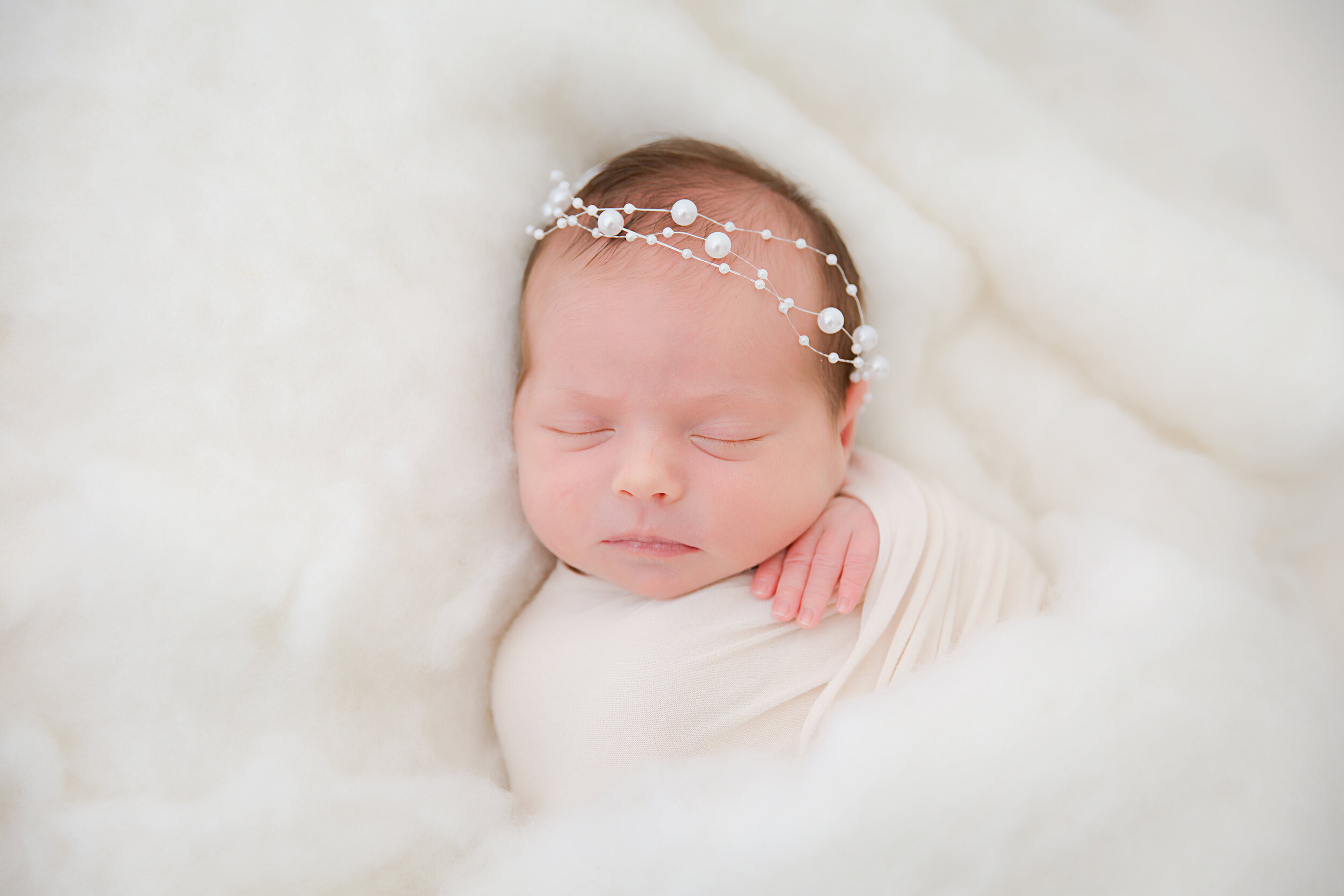 posed-newborn-baby-girl-sleeping-wearing-halo