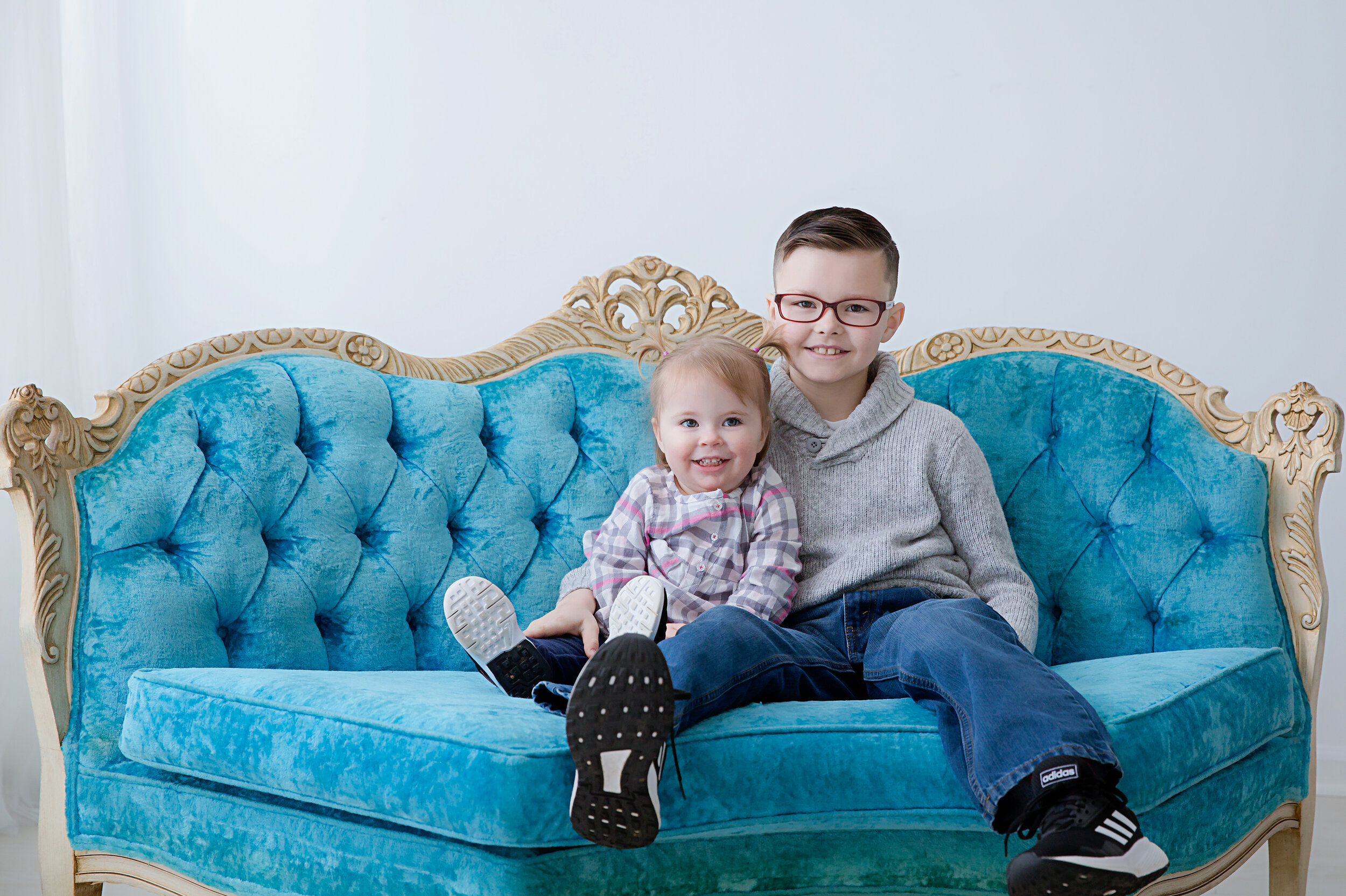 brother and sister on a blue couch