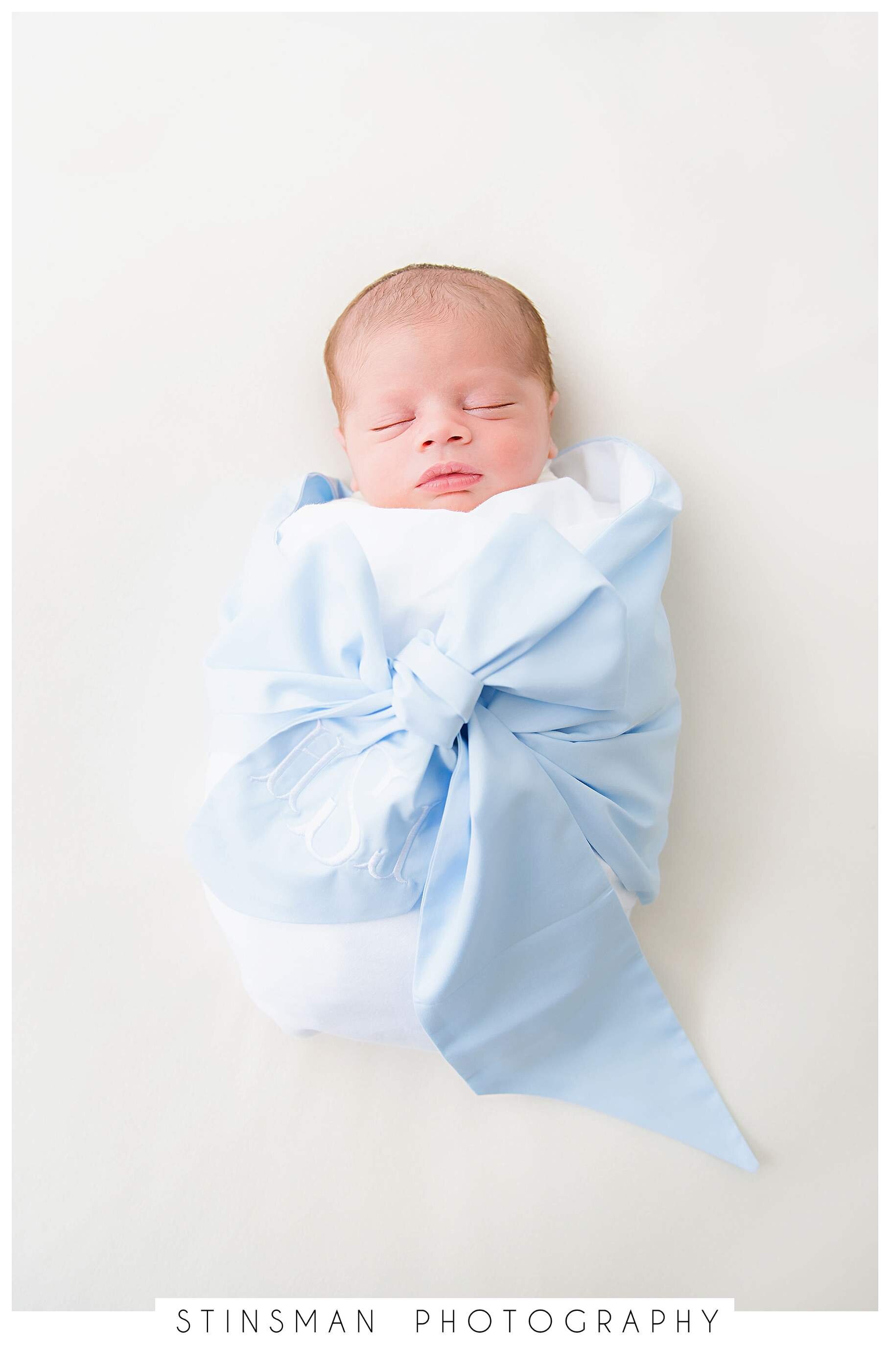 baby-wrapped-in-a-custom-bow-with-monogram.jpeg