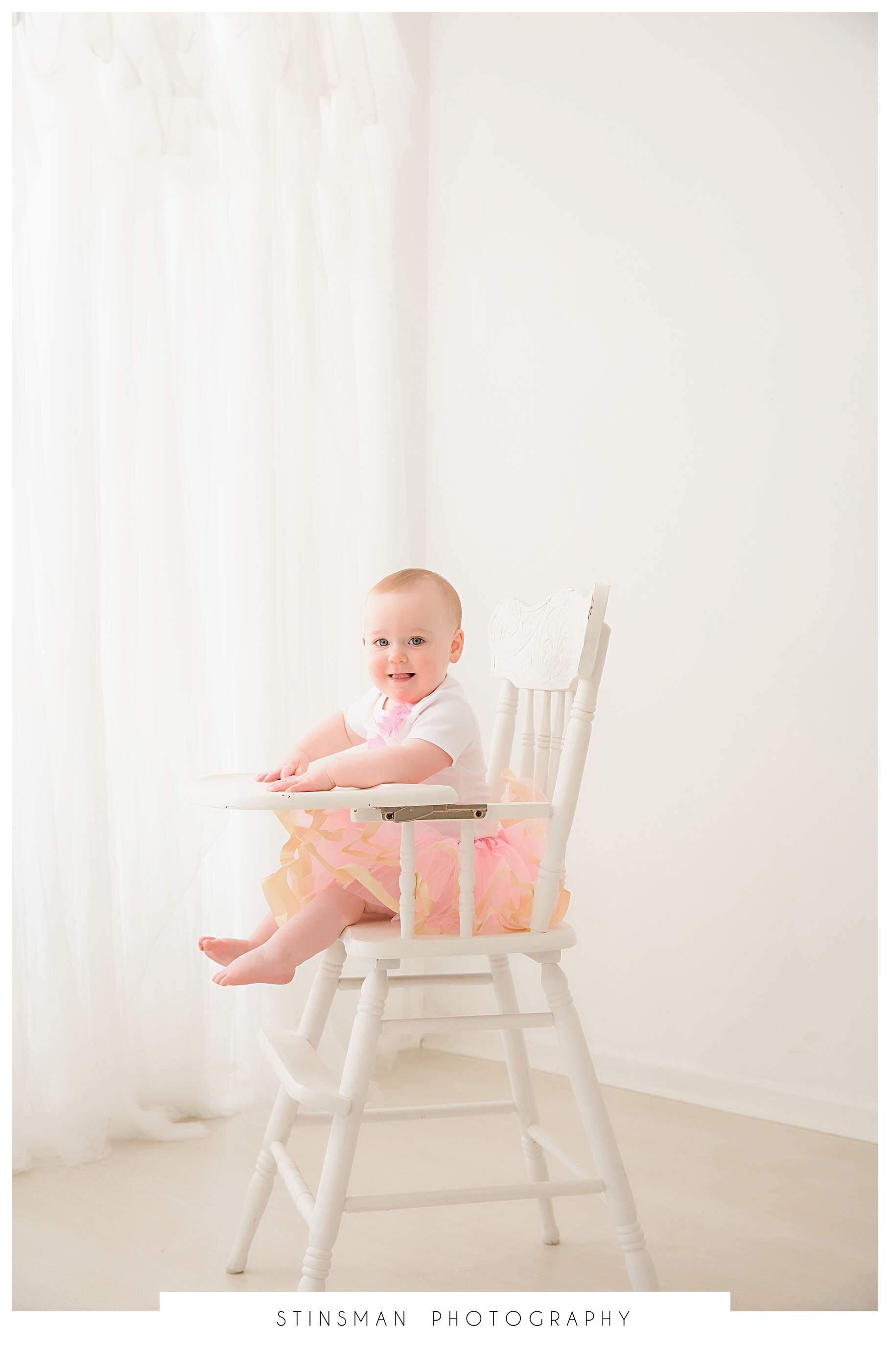 baby-in-high-chair-with-pink-and-gold-tutu.jpeg