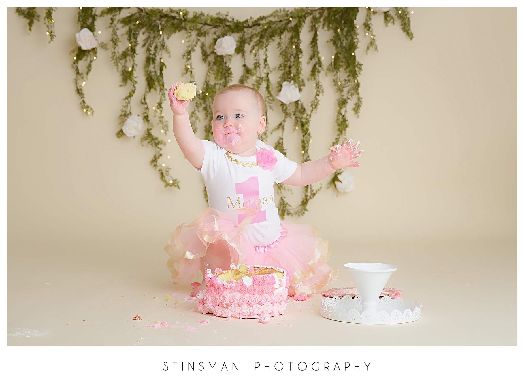 baby-girl-smashing-a-cake-for-her-first-birthday-in-photo-studio.jpeg
