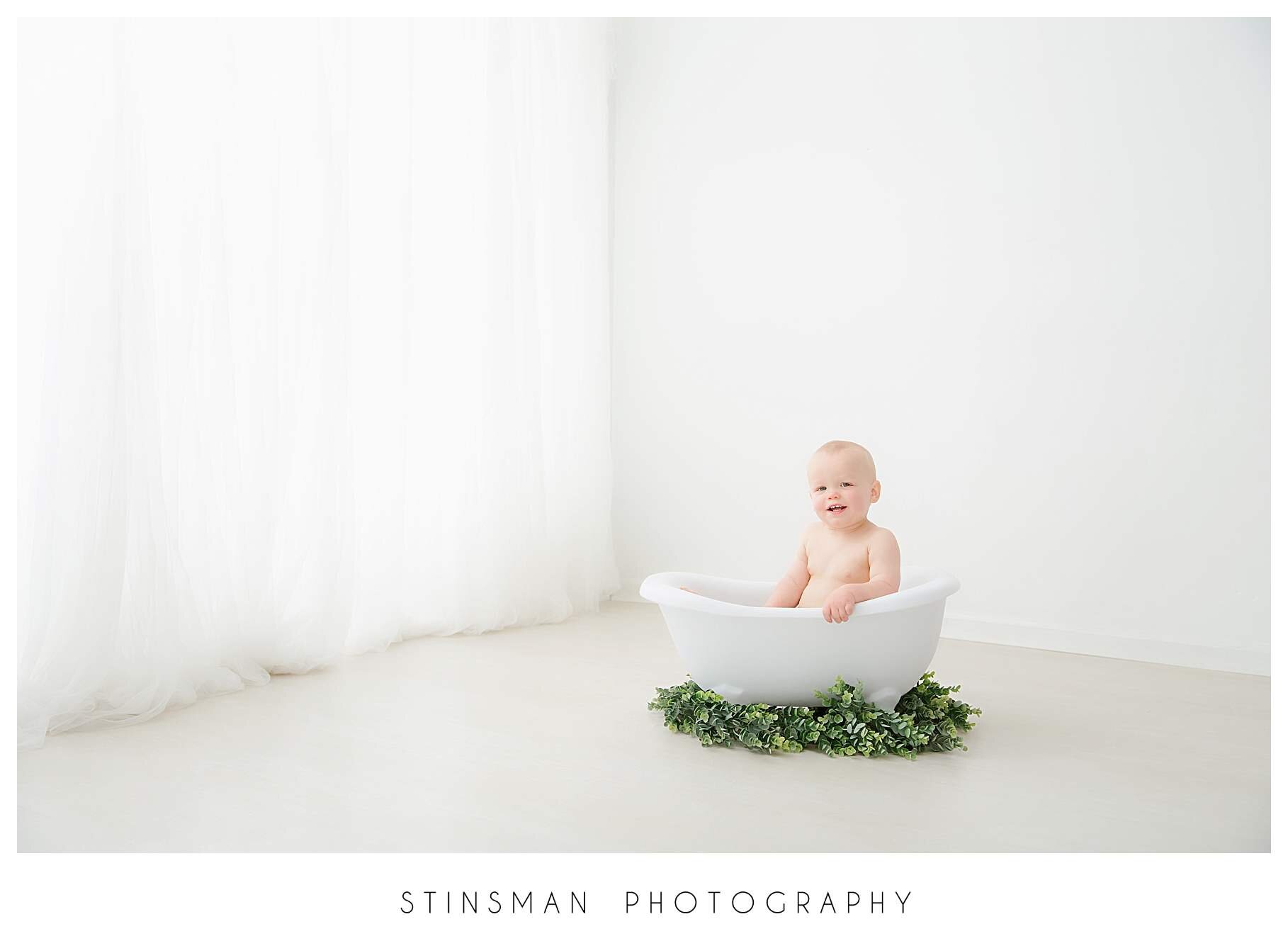 smiling-one-year-old-in-the-tub-for-birthday-pictures.jpeg