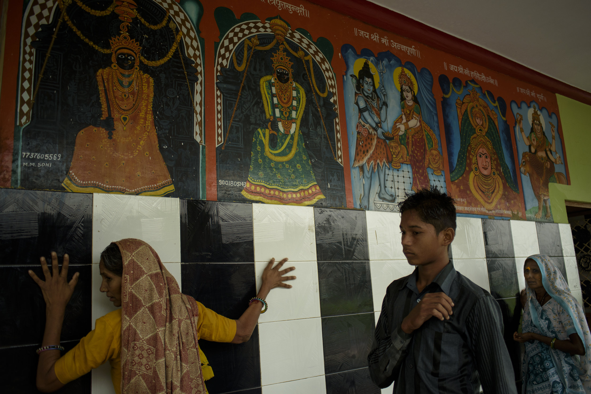  A woman touches the walls of the temple that is commonly known as Kupra Maata Ka Mandir, situated 5 kilometres from Banswara town. The villagers hold immense faith in healing through ceremonies that take place in the temple compound every weekend. 