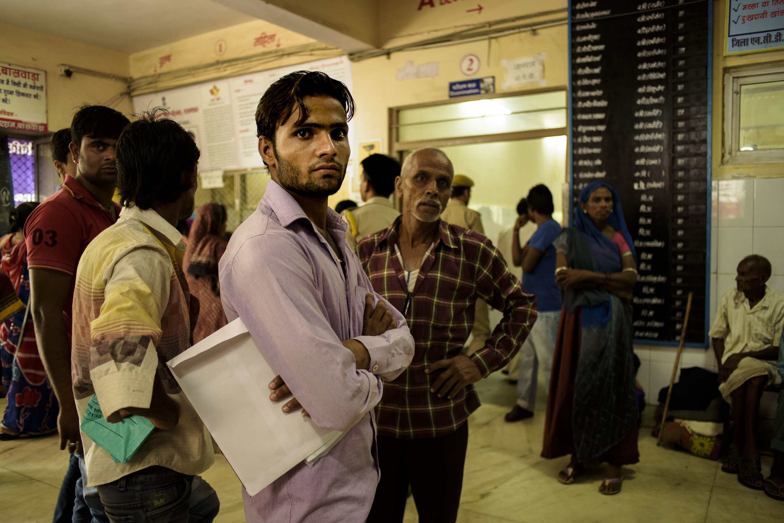 A man waits for his turn to get an appointment with a doctor in the lobby of the Mahatma Gandhi Hospital, Banswara. The district hospital has experiences an influx of more than 800 patients per day.