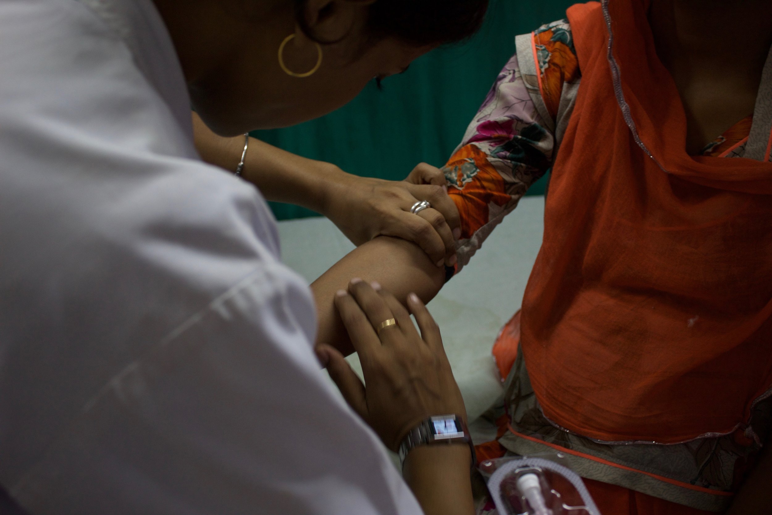  An injection, covered under the Essential Drug List of the MNDY scheme, is administered to a female patient in the in-patient ward of MB Hospital. 