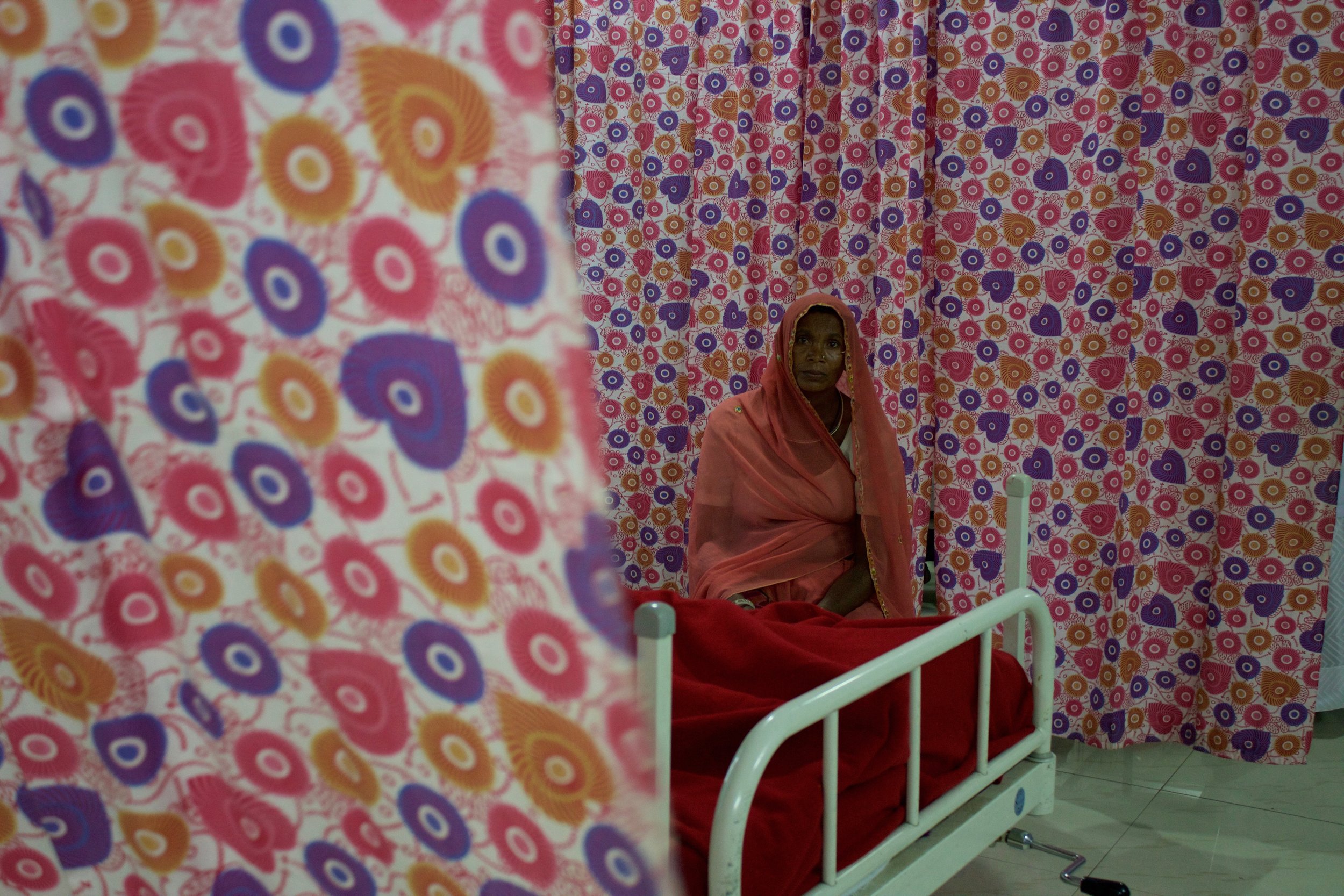  A mother sits by the bedside of her daughter who is being treated, at no cost, for hemorrhaging in the Intensive Care Unit of Zanana Hospital. 