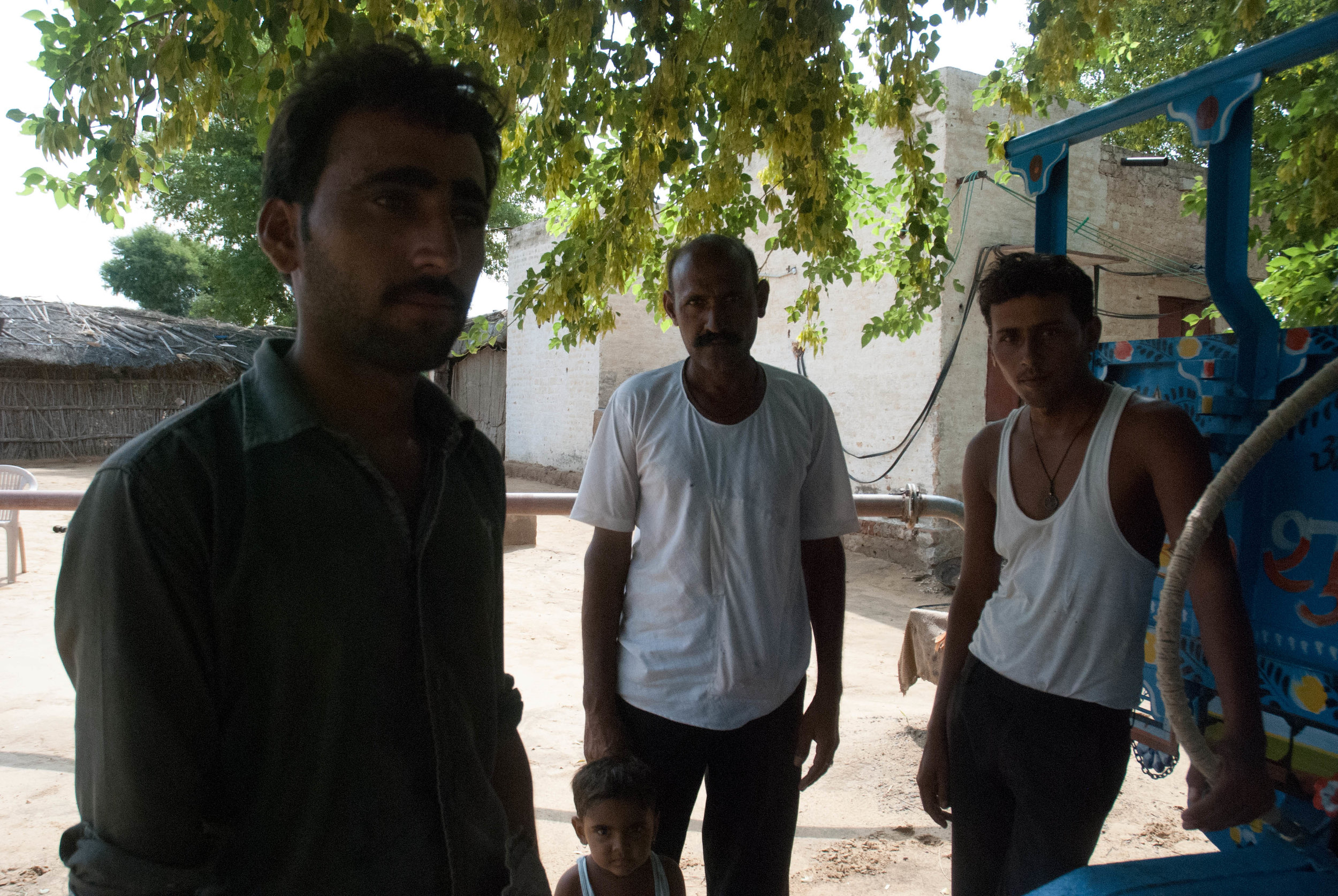  The men of the Siddh family. The father (in the back) works on the farm while his two sons work as tractor drivers. 