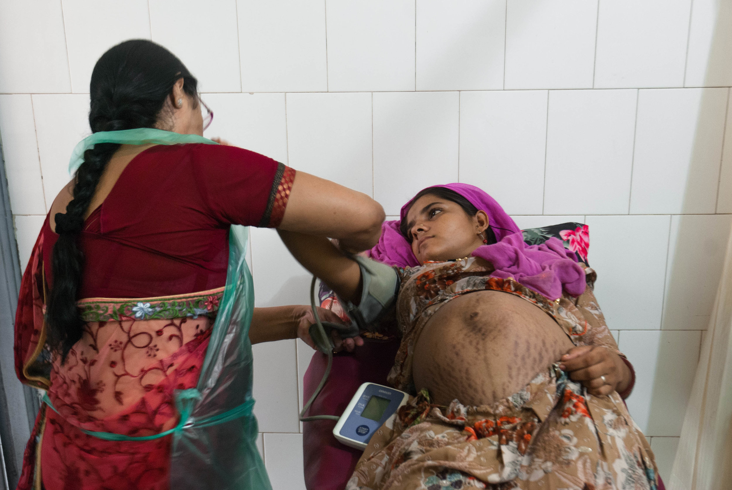 A young mother has her health condition checked before her delivery, due in a few hours.