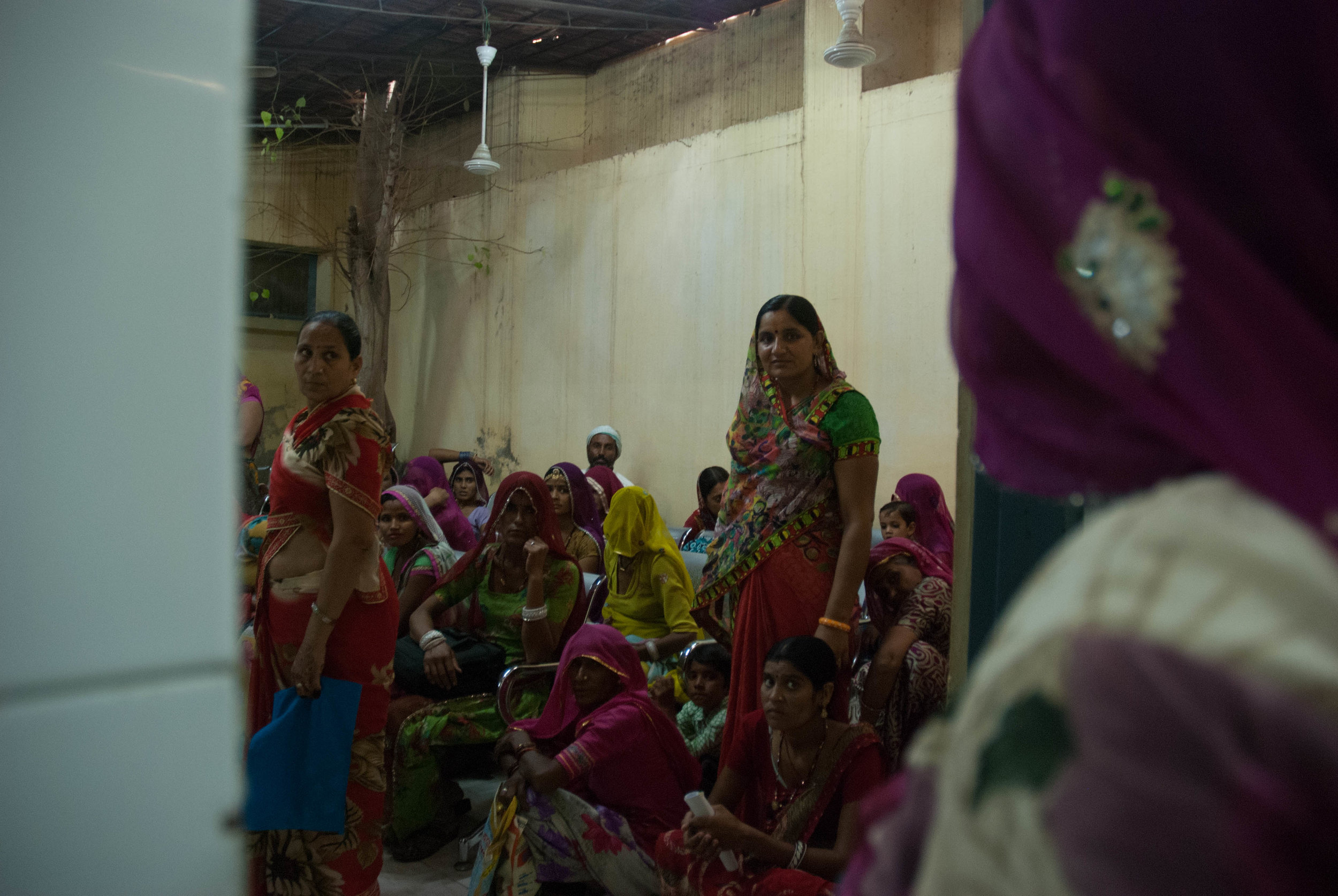  Medical patients crowd into a room, waiting to be called to retrieve their blood test results at the District Hospital, Bikaner. 