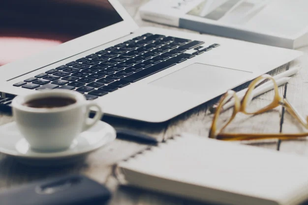 closeup-of-workspace-with-modern-creative-laptop-cup-of-coffee-and-pencils-horizontal-with-copy-space_1220-1857.jpg