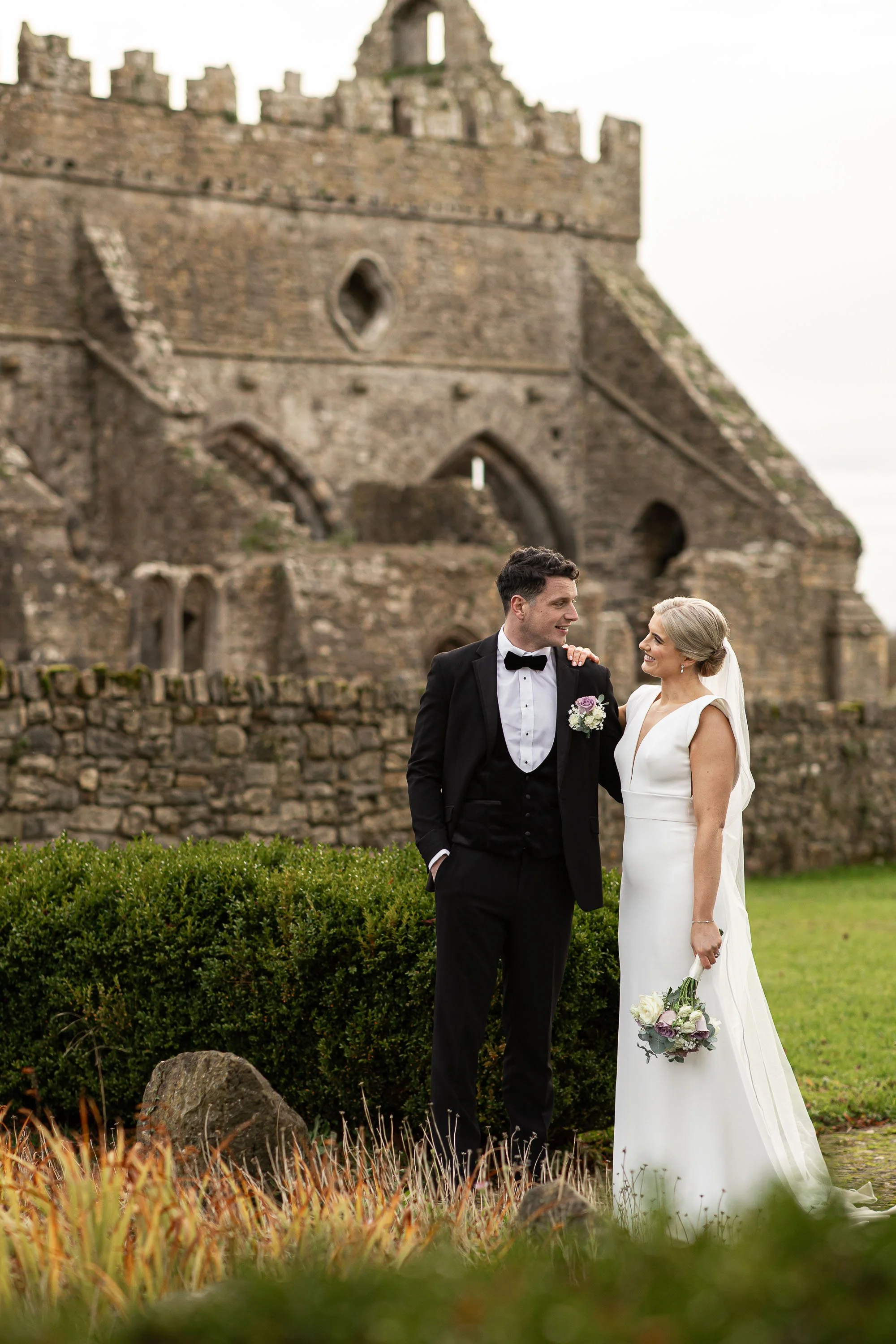 gowran-abbey-bride-and-groom-share-a-smile-folkster-gowns-kate-tobin-liam-ryan-wexford-senior-hurler-donal-o'connor-oc-wedding-videography-daragh-mccann-stargaze-photography.jpg