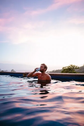guy drinking in pool.jpg