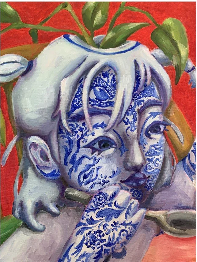 Image Description: Soft, young face of the blue and white head with intricate blue patterns and blue lips  close up.