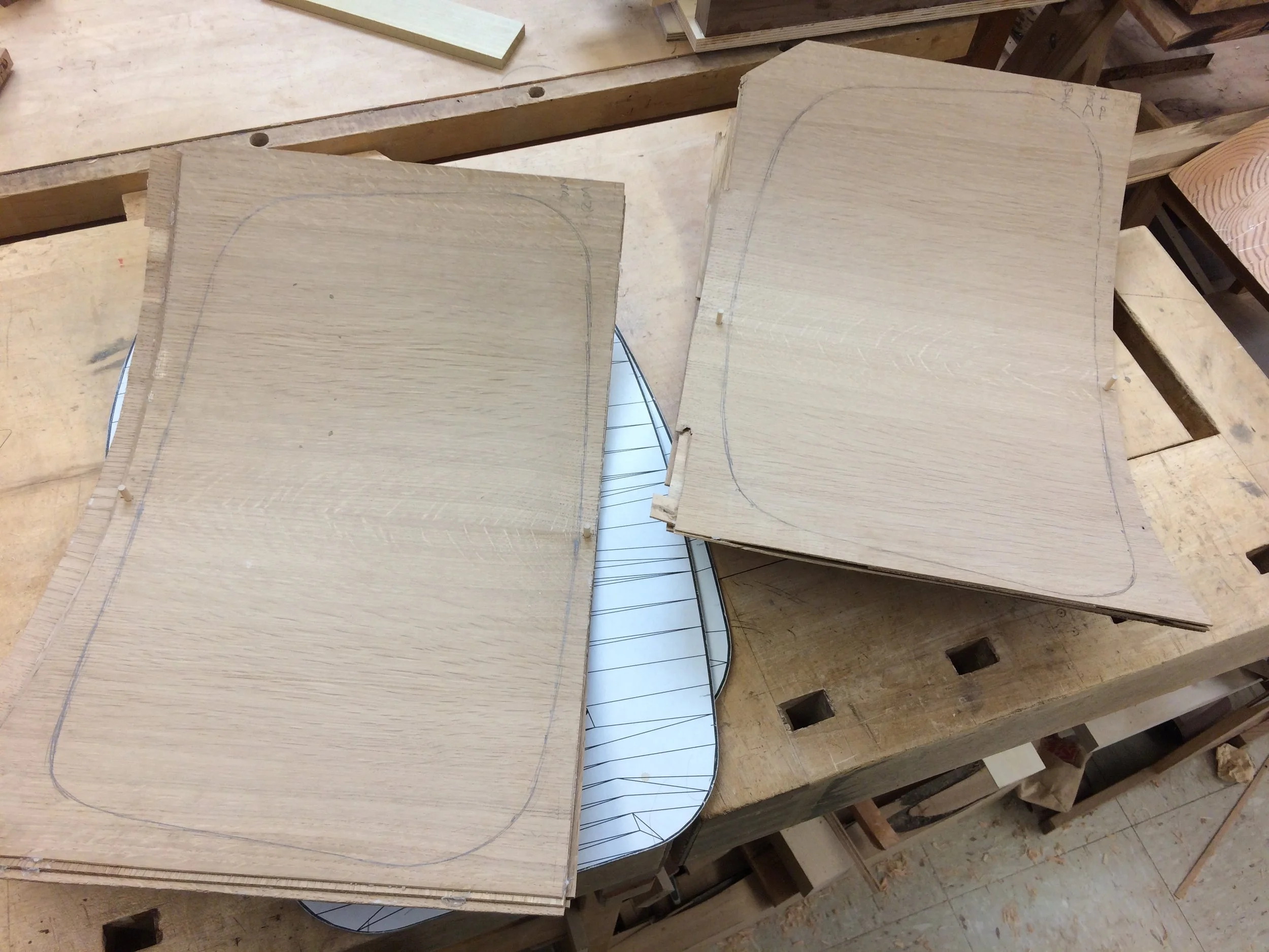 After a few hours in the press, the plywood shells are marked for bandsawing to the final contour.