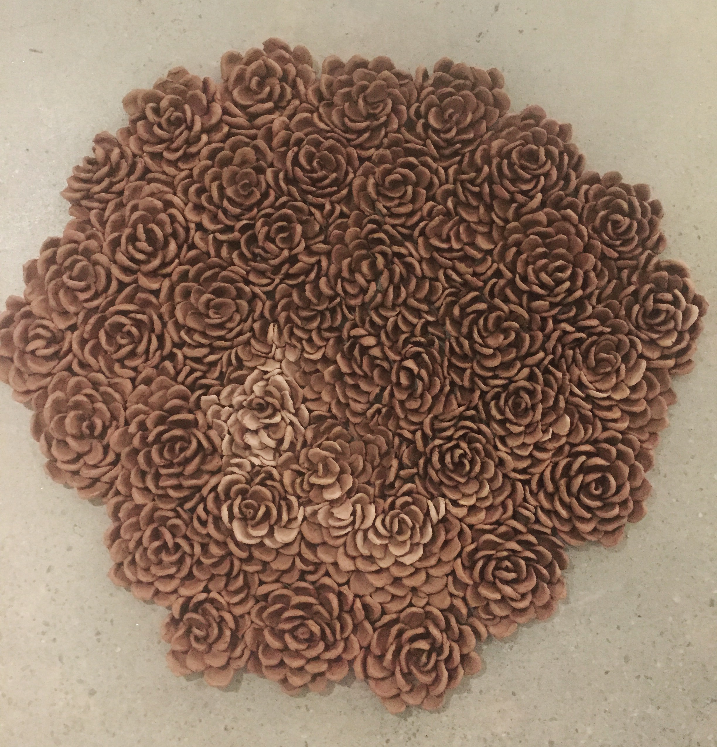  25 pounds of clay flower petals leaning against each other. Over 10 hours. Late 2015. 